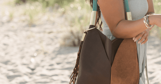 brown leather bag with seaweed tassel on the beach