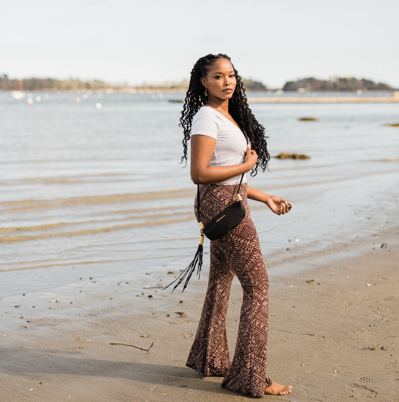 woman wearing black leather clam shell bag