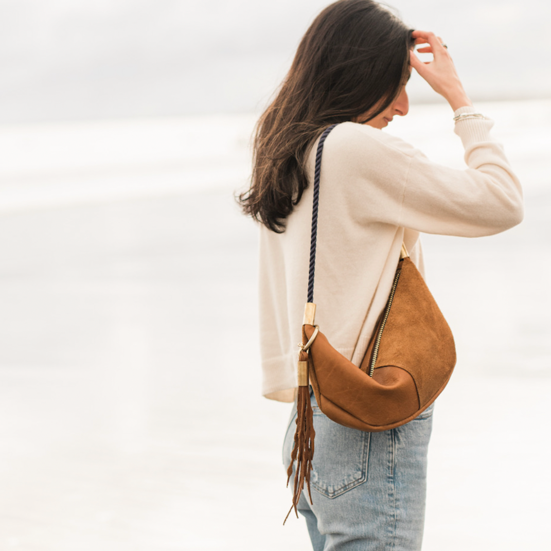 woman wearing beachnut leather zip sling bag