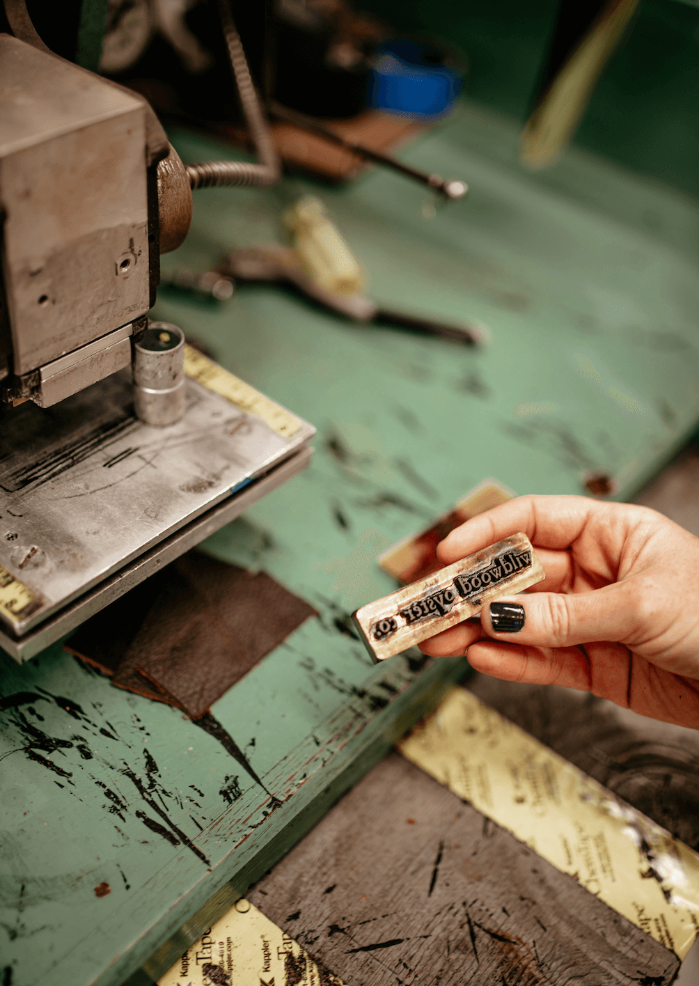 person holding a metal brand