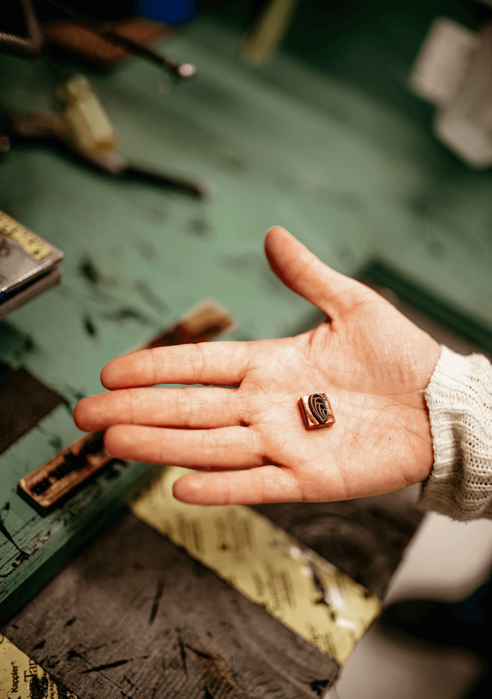 hand with a metal shell brand on it