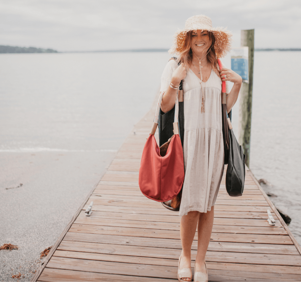 woman carrying a lot of bags on a dock