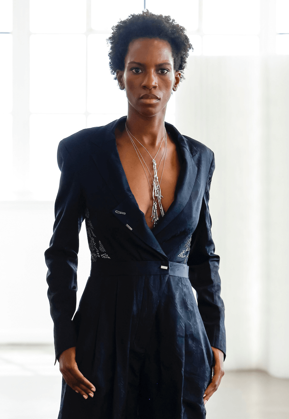 woman wearing a black dress and layered seaweed necklaces