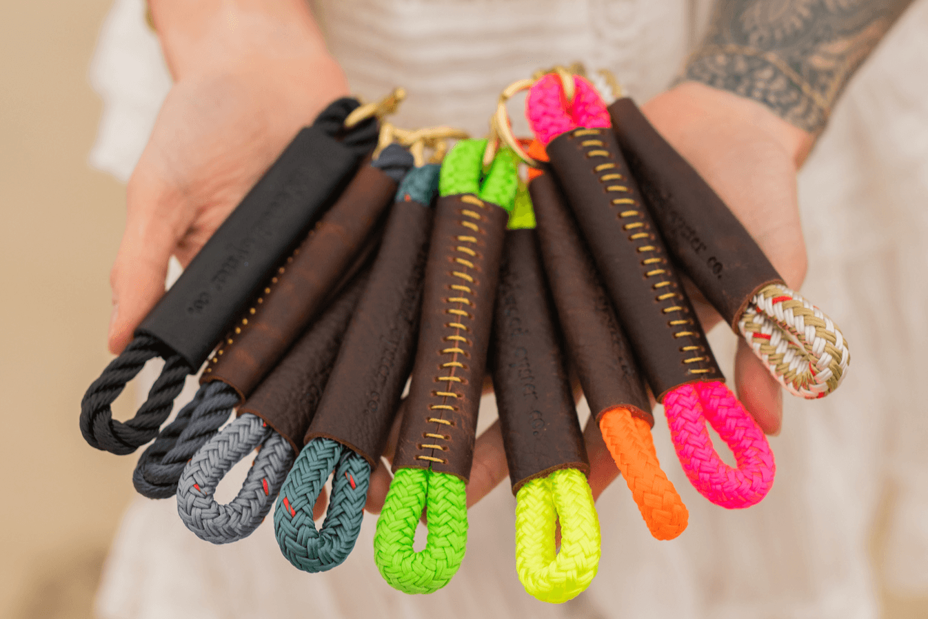 rainbow assortment of rope keychains with leather