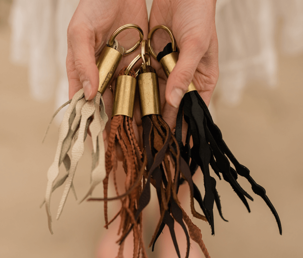 brown, gold, and black leather seaweed tassel keychains