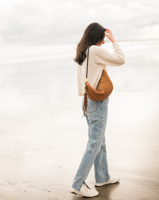 woman wearing beachnut leather zip sling bag