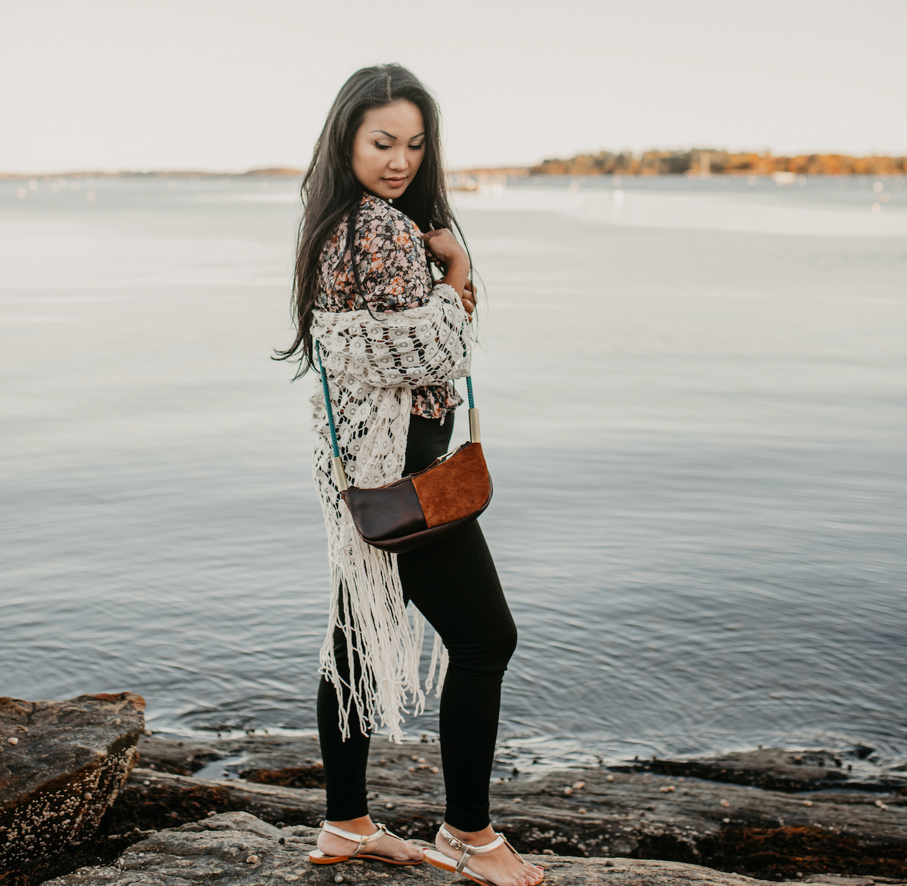 woman wearing brown leather zip crossbody bag