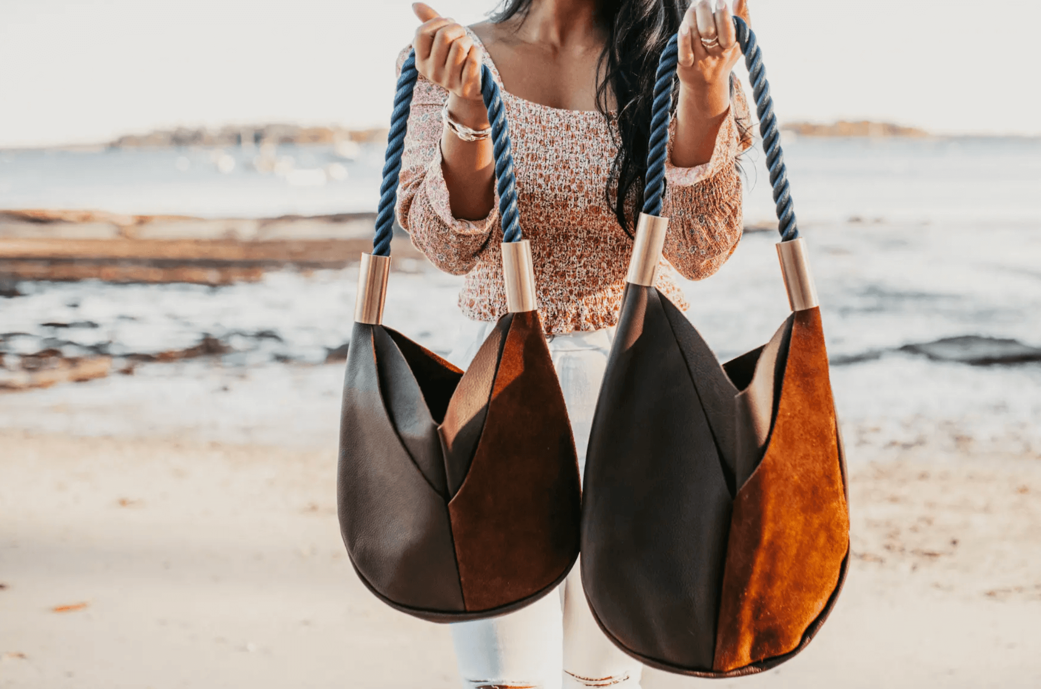 woman holding two leather bags