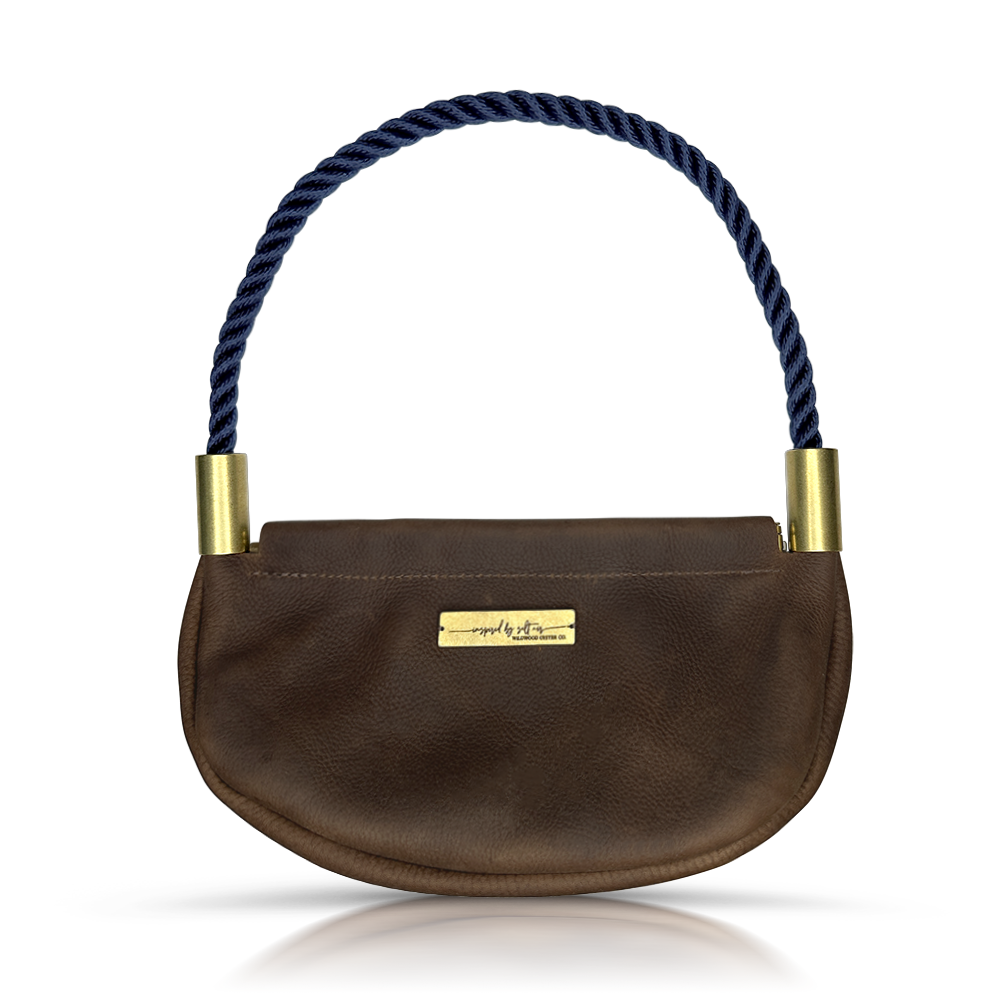 brown leather clam shell bag with navy dockline