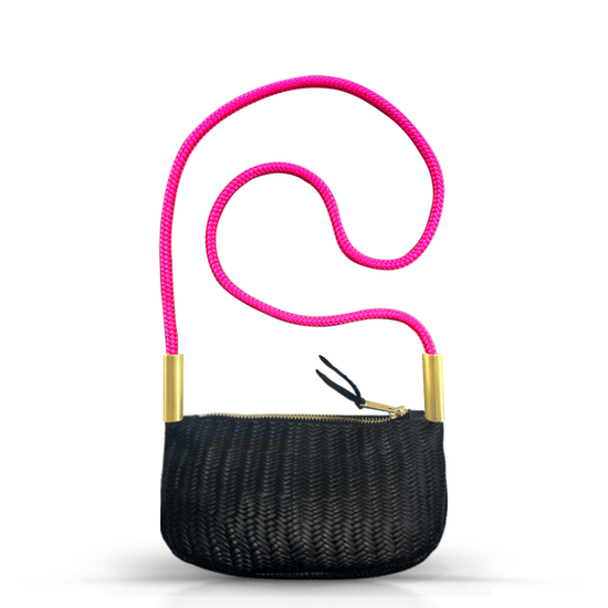 black basketweave leather zip crossbody tote with neon pink dock line handle