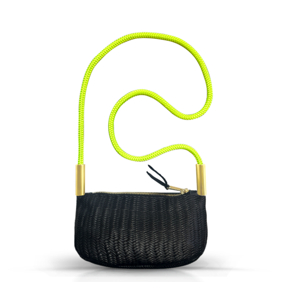 black basketweave leather zip crossbody tote with neon yellow dock line handle