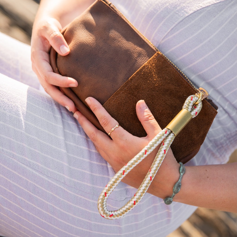 closeup of brown leather makeup bag with dock line rope